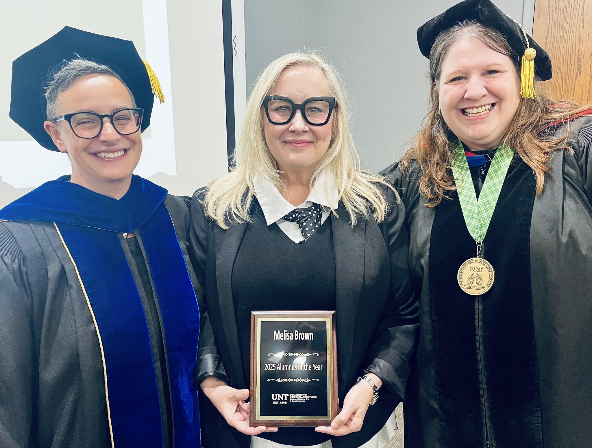 Megan Morrissey, Melisa Brown, and Suzanne Enck posing with Alumnus of the Year Award