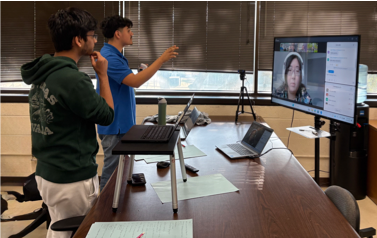Debaters standing by Zoom meeting on TV cross examining a virtual participant