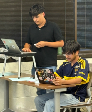 Two debaters participating in a virtual tournament at their laptops