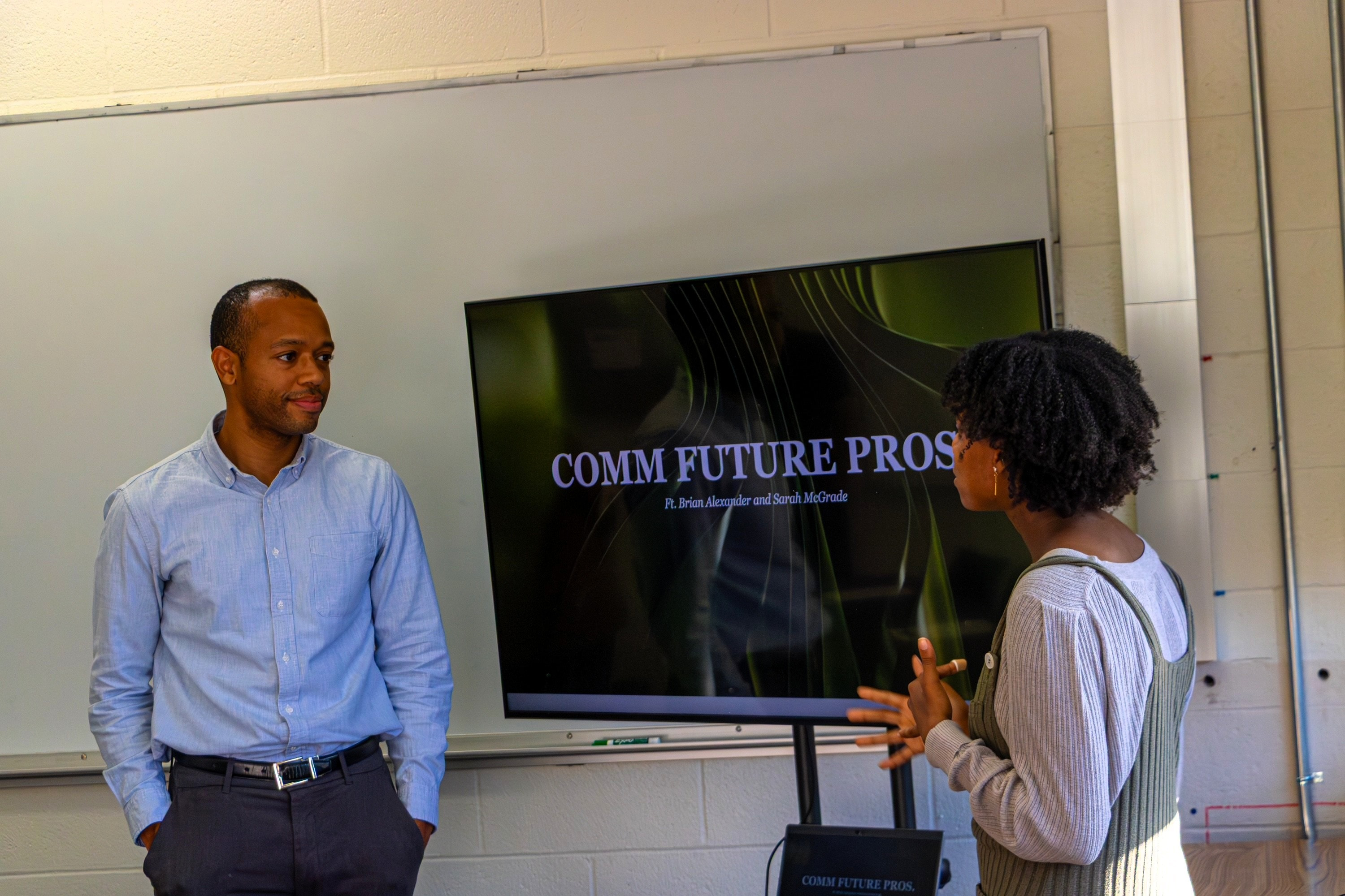 Student asking Brian McGrade a question during presentation