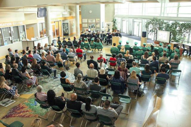 Overview shot of commencement ceremony attendees from behind