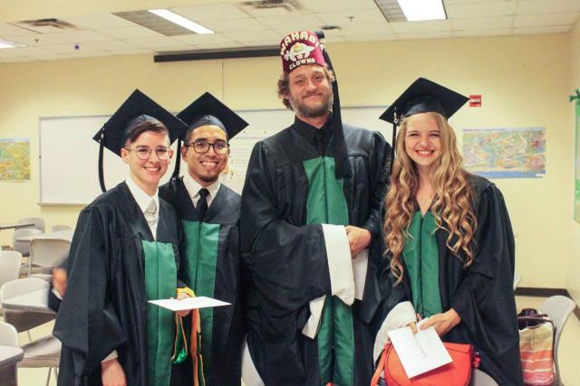 Graduating master's students smile for picture