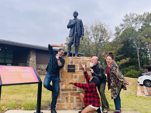 Petit Jean participants post in front of statue at park