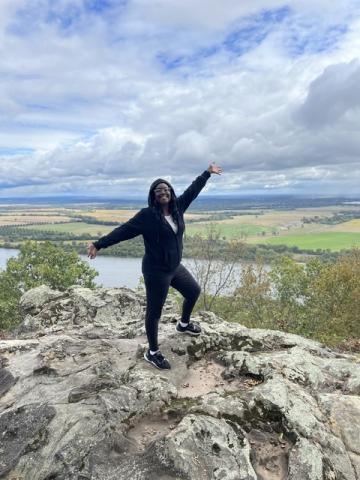 Dr. Sasha Sanders standing on mountain