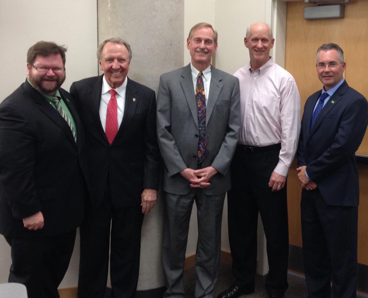 Men in suits posing for a picture