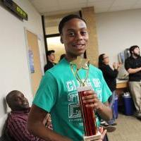 UNT Debater posing with trophy