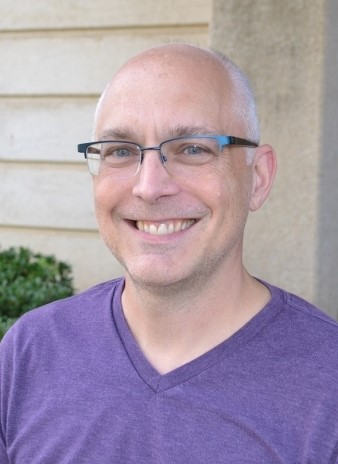 Jeff Rous, Ph.D. posing in front of building