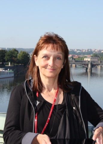 Margie Tieslau, Ph.D. posing on bridge on the Seine River