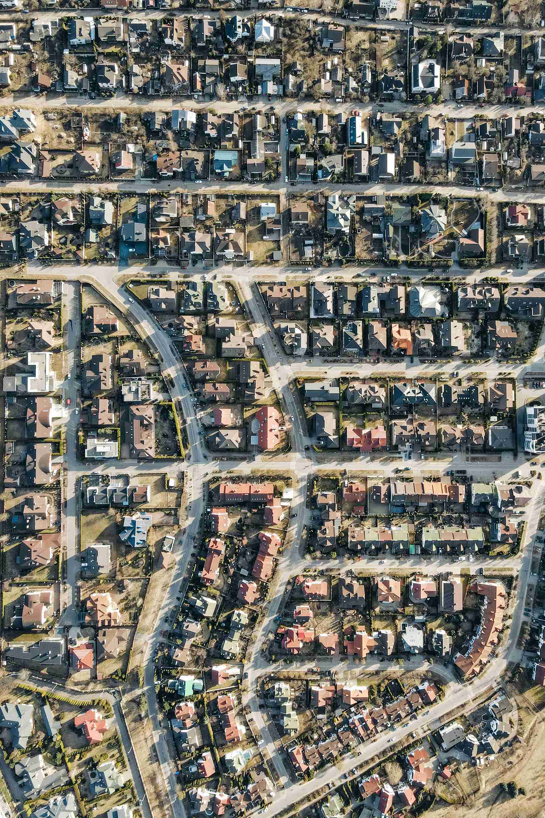 Aerial view of a suburban neighborhood with houses, streets, and blocks arranged in a grid pattern