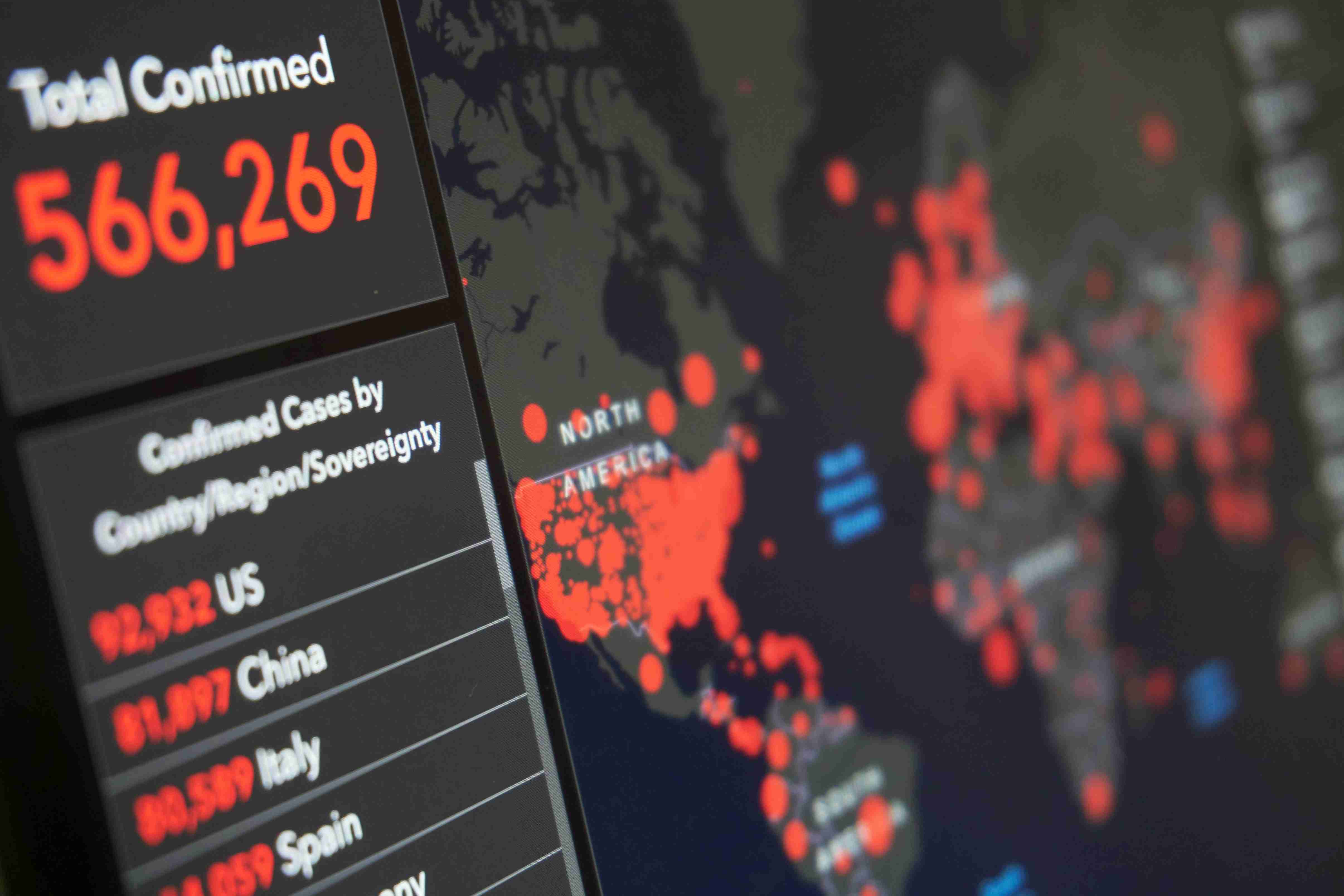 COVID-19 pandemic map dashboard showing total confirmed cases and global hotspots in red