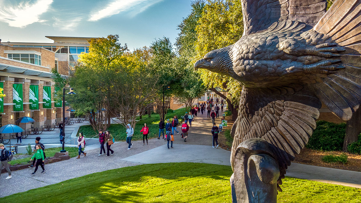 Eagle statue overlooking students on campus
