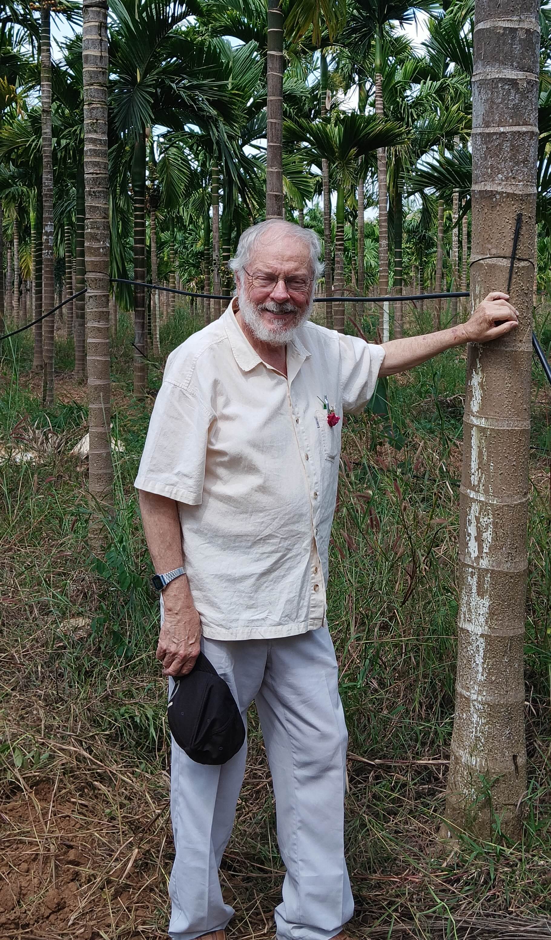 man standing next to a tree