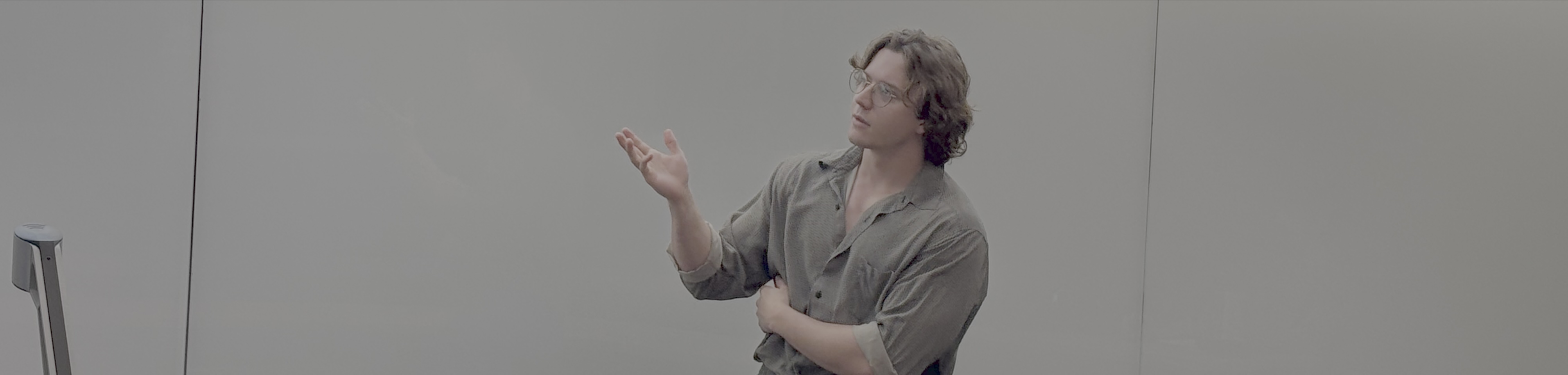 A person standing in front of a white board