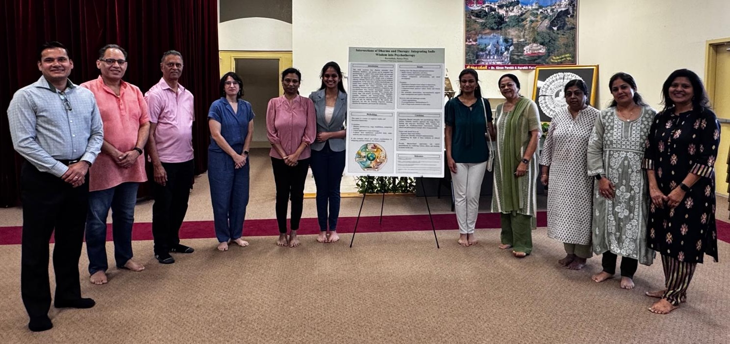 People stand in a row around a poster presentation.