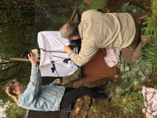 Two people arrange materials for a photo shoot.