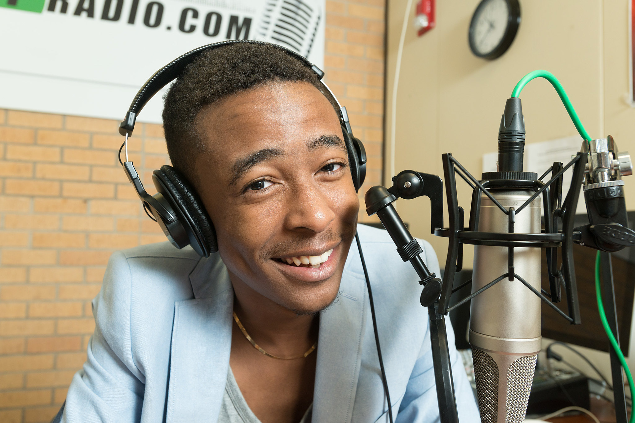 student speaking into studio microphone