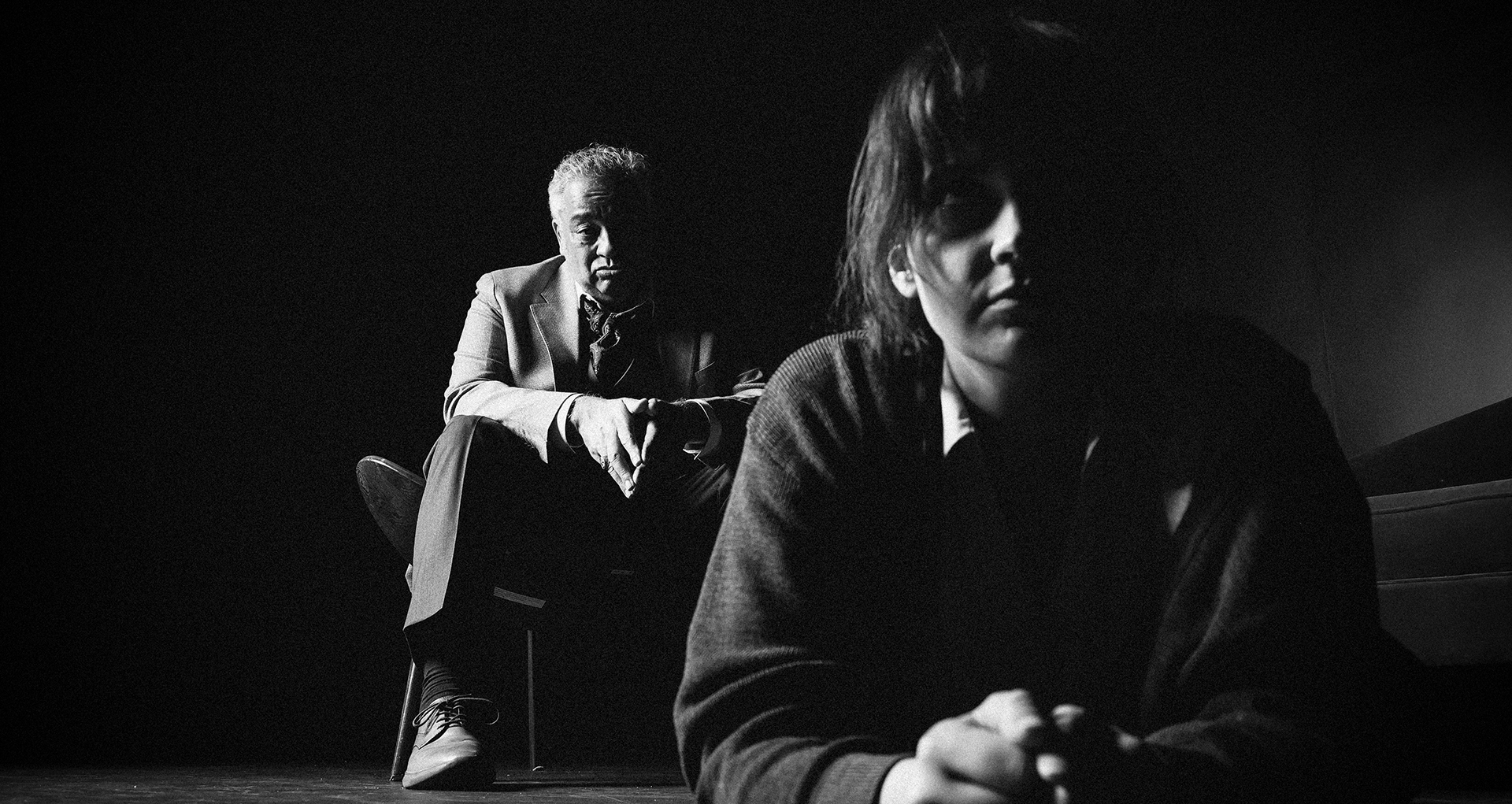 Promotional still from set in black and white