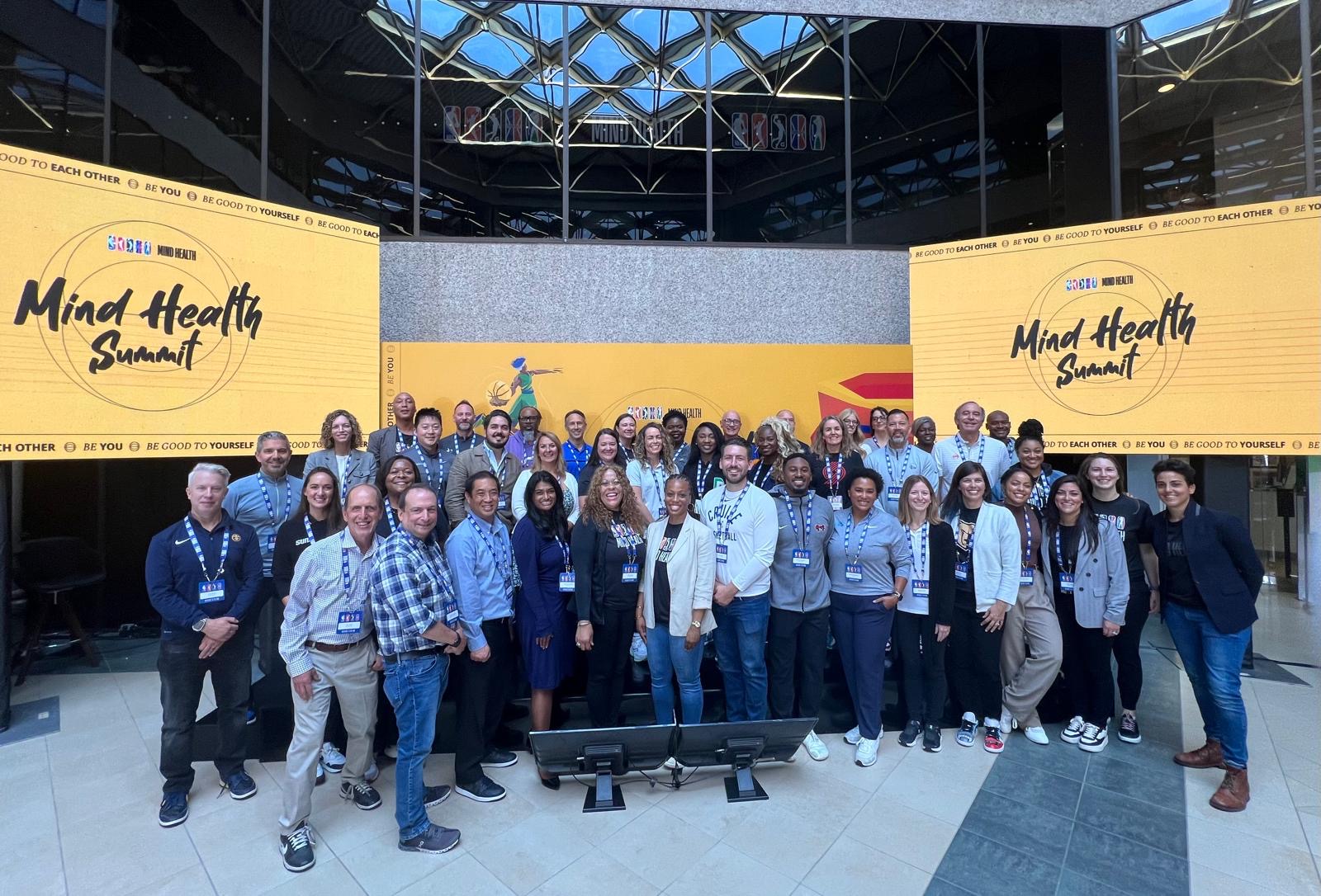 Group photo of presenters in a stadium